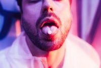 cropped-view-man-closed-eyes-lsd-tongue